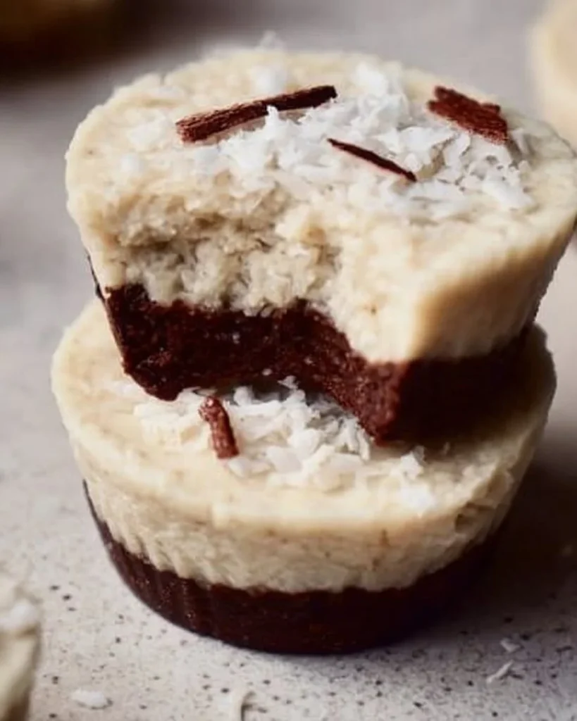 Delicious no-bake vegan coconut cups stacked on a plate.