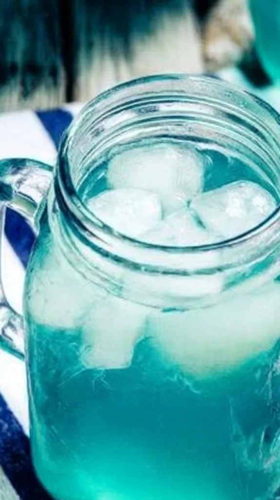 Cinderella Cooler Mocktail in a glass with fresh fruits and ice