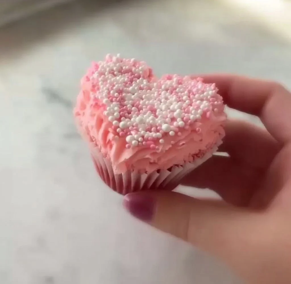Delicious homemade Valentine's Day Cupcakes decorated with hearts and pink frosting.