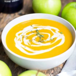 Delicious bowl of creamy butternut squash soup garnished with herbs