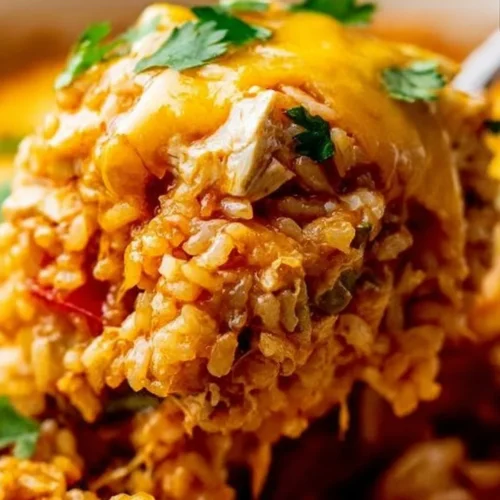 Chicken Enchilada Rice Casserole topped with cheese and fresh cilantro