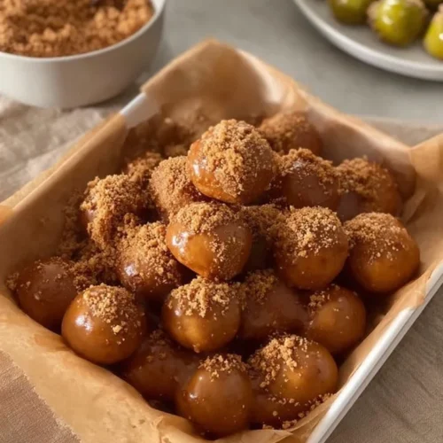 Delicious cookie butter fried dough served with a dusting of powdered sugar