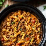 Crockpot Taco Pasta garnished with cheese and cilantro in a bowl