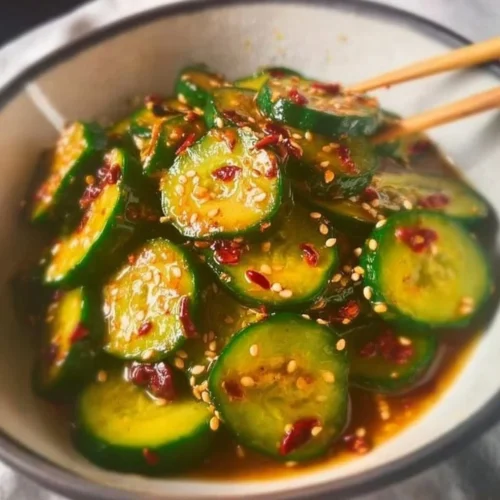Bowl of easy Asian cucumber salad with sesame dressing and colorful vegetables