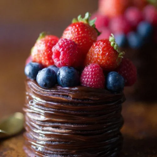 Mini Double Chocolate Berry Cakes topped with fresh berries and chocolate drizzle