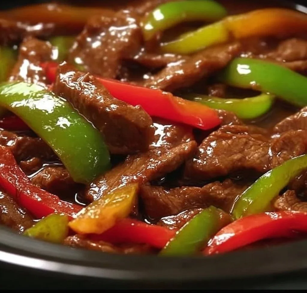 Tender crock pot pepper steak served with vegetables and rice
