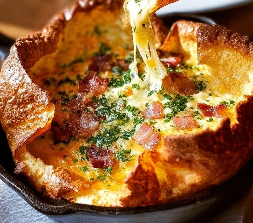 Savory Cheddar Turkey Bacon Dutch Baby topped with crispy turkey bacon and melted cheddar cheese