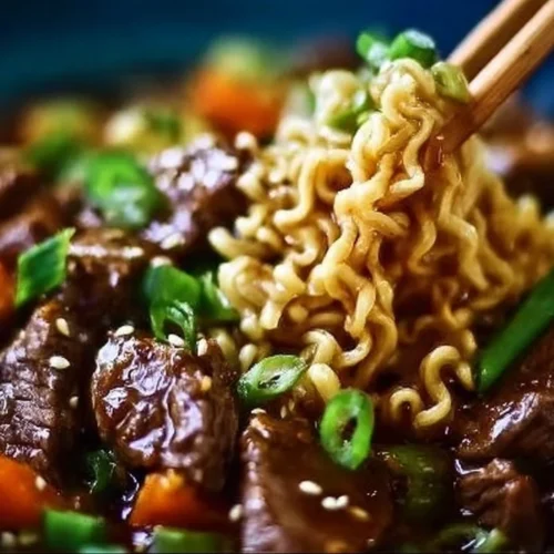 Slow cooker beef ramen noodles topped with green onions and chili oil