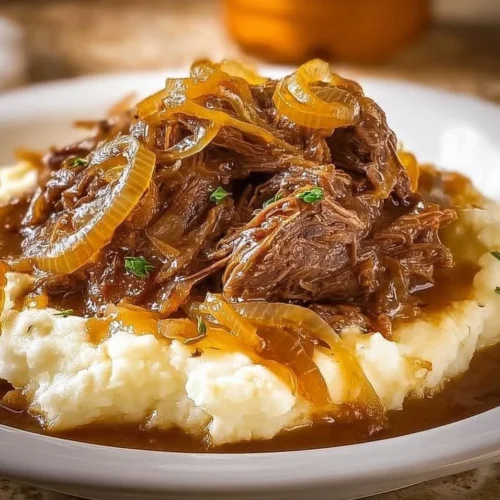Delicious Crock Pot French Onion Pot Roast served with herbs and onions