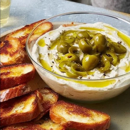 Delicious Blue Cheese-Stuffed Olive Dip served in a bowl with crackers