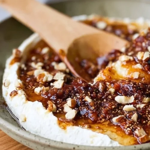 Boursin cheese dip with figs appetizer garnished with herbs