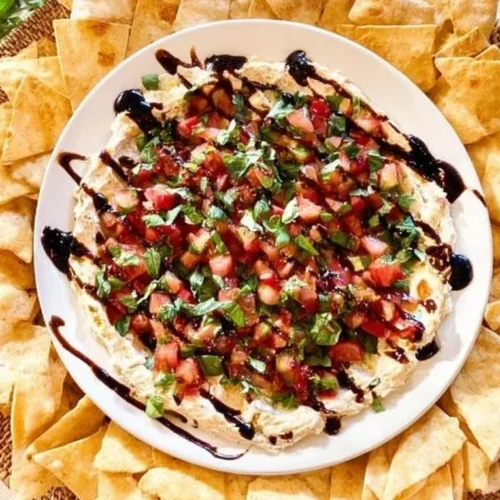 Delicious bruschetta dip served with toasted bread and fresh herbs.