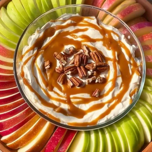 Delicious caramel apple cheesecake dip served in a bowl with apple slices