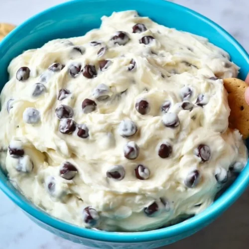 Delicious chocolate chip cheesecake dip served in a bowl with a spoon