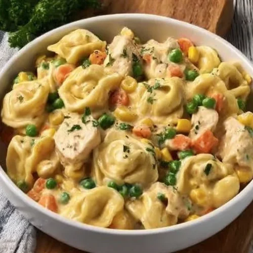 Crockpot cheddar chicken pot pie with tortellini served in a warm bowl