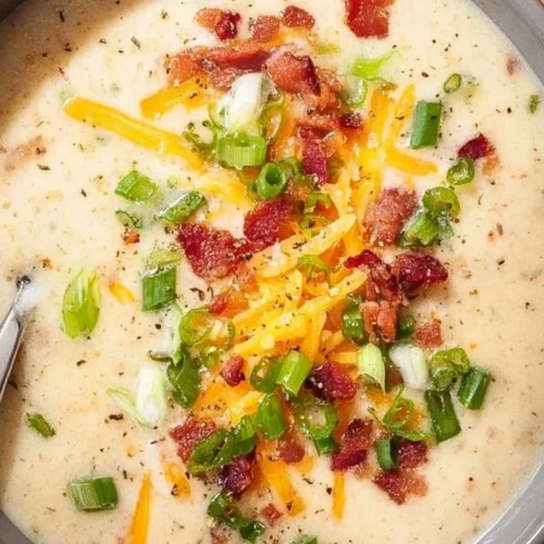 Creamy Crockpot Potato Soup served in a bowl with toppings