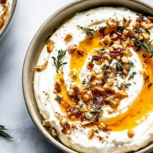 Creamy ricotta dip drizzled with hot honey served in a bowl