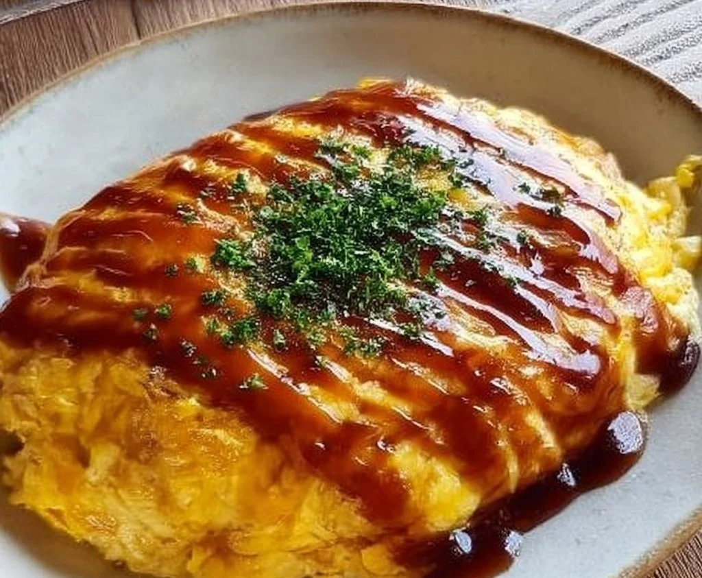 Japanese fried rice omelette topped with fresh herbs and served on a plate