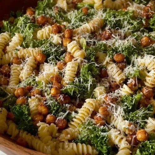 Kale Pasta Caesar Salad with creamy dressing and croutons served in a bowl