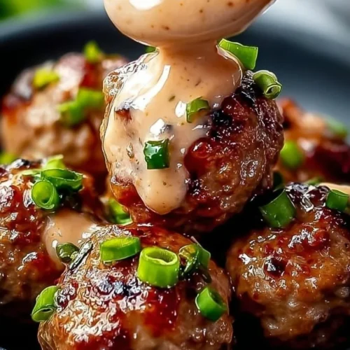 Korean BBQ Meatballs served with a spicy mayo dip on a plate.