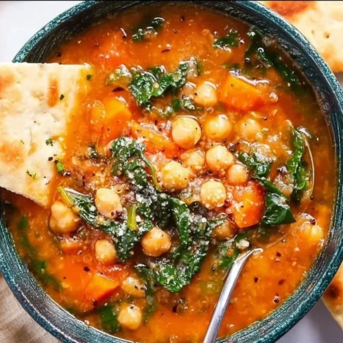 Bowl of flavorful Mediterranean soup with fresh vegetables and herbs