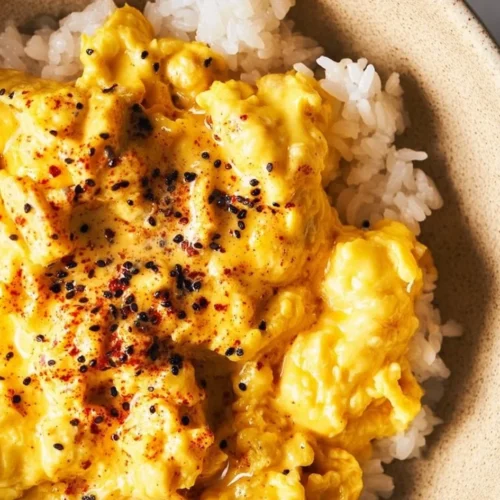Delicious miso scrambled eggs served on a plate with fresh herbs and toast.