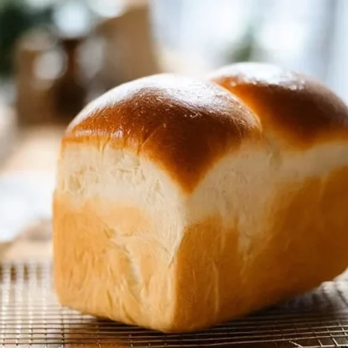 Freshly baked Shokupan, the iconic Japanese milk bread, sliced and ready to enjoy.