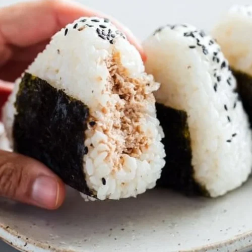 Spicy tuna rice balls served on a plate with garnish