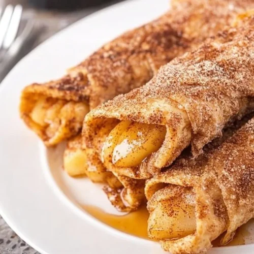 Delicious Air Fryer Apple Pie Taquitos ready to be served with a scoop of ice cream.