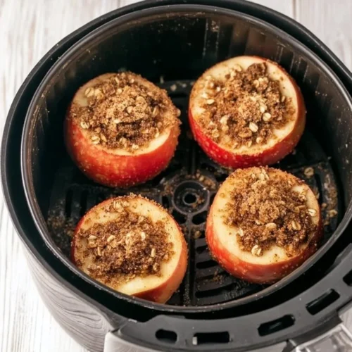 Delicious air fryer baked apples topped with cinnamon and caramel.