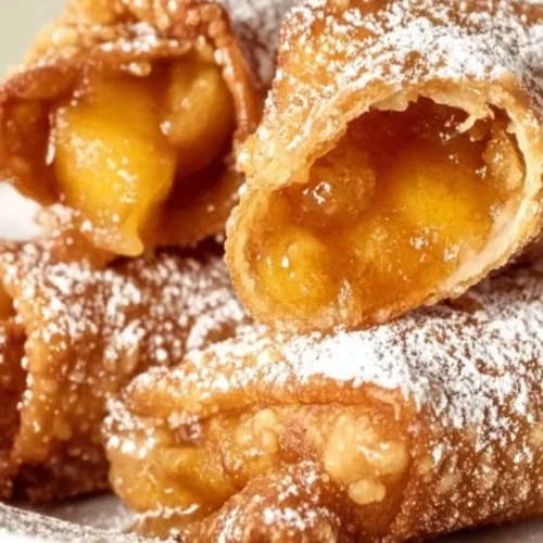 Air Fryer Peach Cobbler Egg Rolls with golden crust and peach filling
