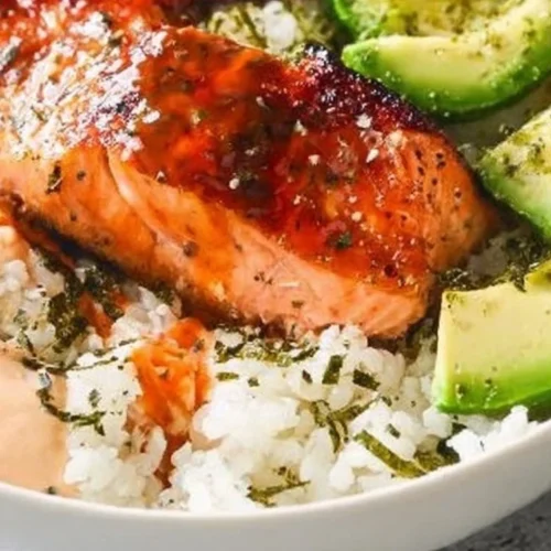 Baked salmon sushi bowl with fresh vegetables and rice