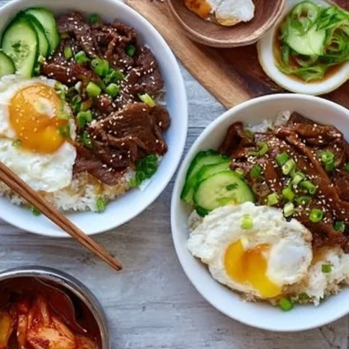 Delicious Beef Bulgogi Bowl topped with fresh vegetables and rice.
