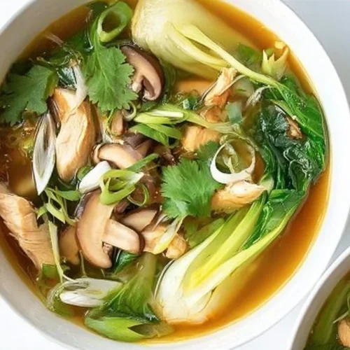 Bok Choy Chicken Soup in a bowl garnished with herbs