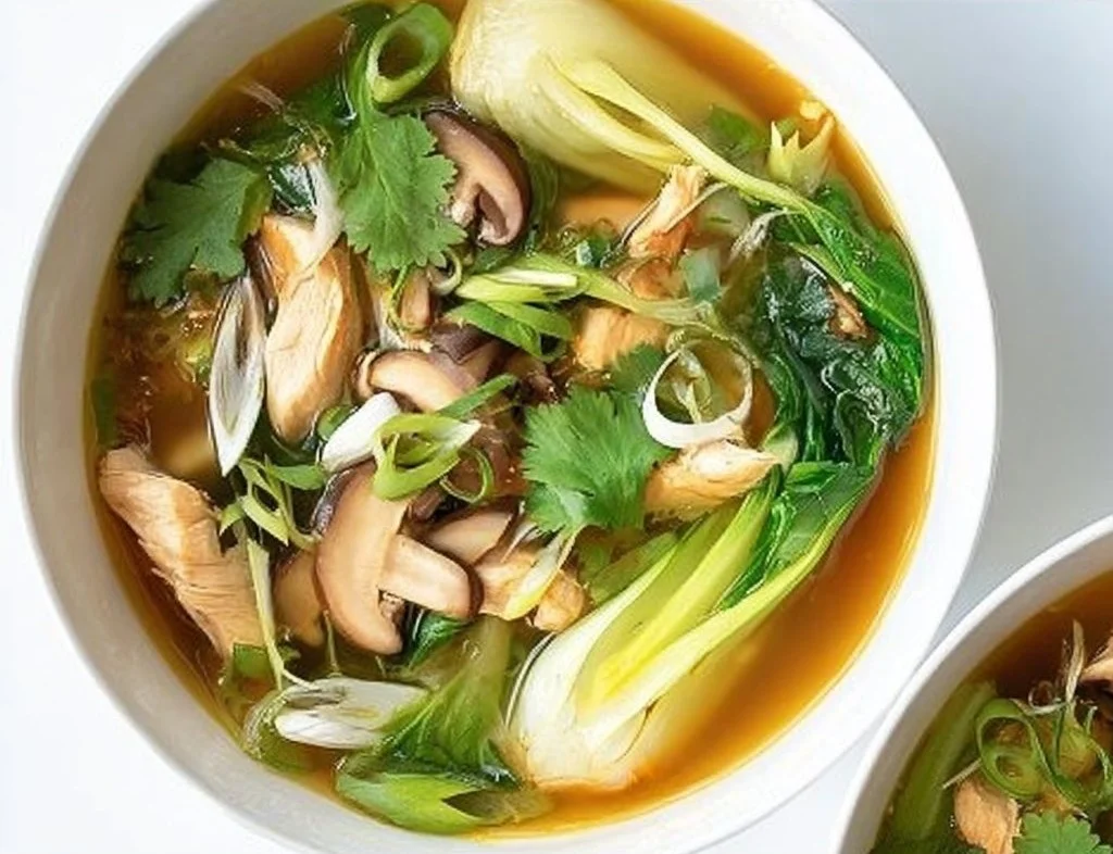 Bok Choy Chicken Soup in a bowl garnished with herbs
