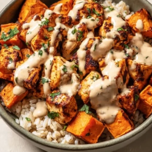 Chicken and Sweet Potato Rice Bowl with colorful vegetables and herbs