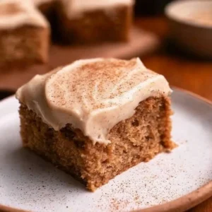 Delicious cream cheese chai cake served on a rustic wooden table