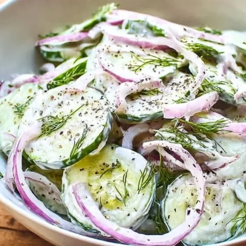 Delicious creamy cucumber salad served in a bowl