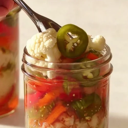 Easy giardiniera recipe with colorful pickled vegetables in a jar.