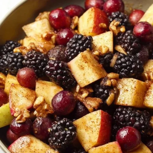 Vibrant fall fruit salad with seasonal fruits like apples, pears, and grapes