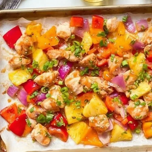 Hawaiian Chicken Sheet Pan Dinner with colorful vegetables and pineapple