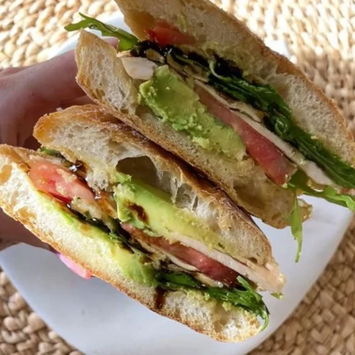 Healthy Mediterranean sourdough sandwich with fresh vegetables and fillings