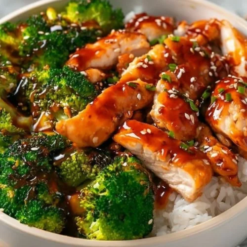 Healthy sticky chicken bowl with colorful vegetables and rice