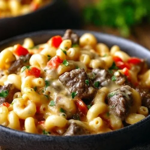High-protein creamy Philly cheesesteak mac and cheese in a serving bowl