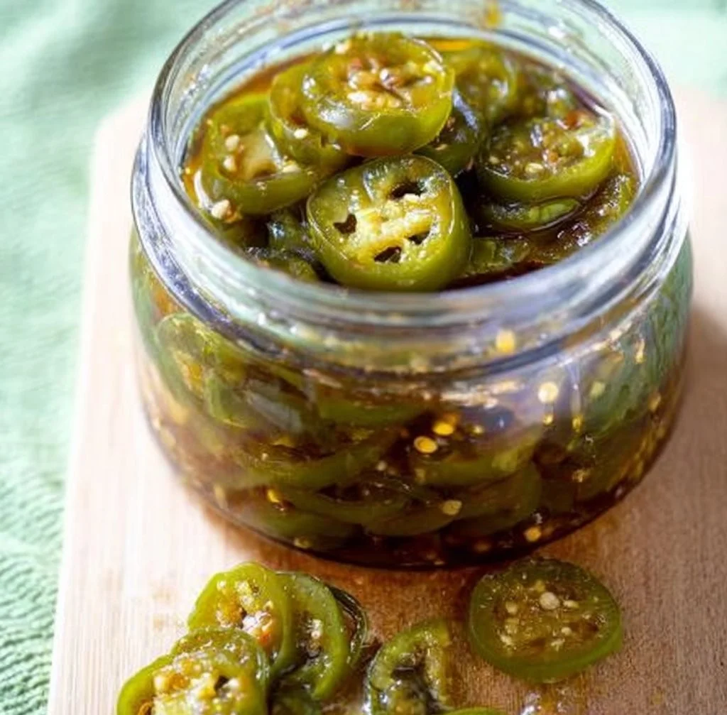 Canning process for sweet and spicy candied jalapenos in jars.