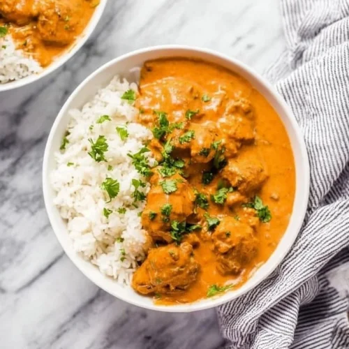 Delicious Instant Pot butter chicken served with rice and garnish
