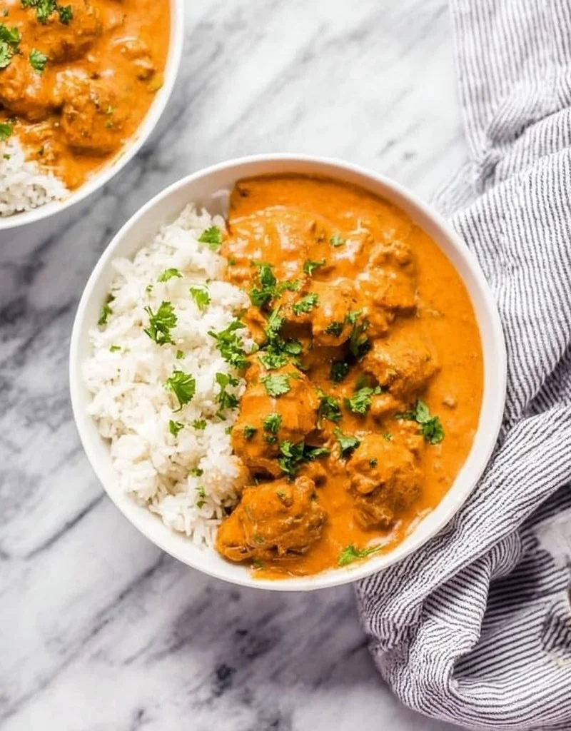 Delicious Instant Pot butter chicken served with rice and garnish