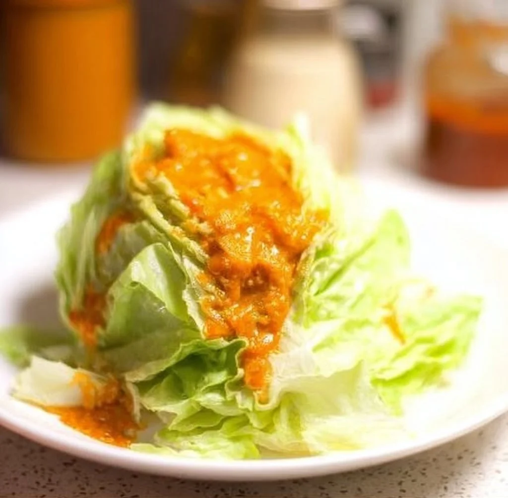 Bowl of Japanese carrot ginger dressing served with fresh salad.