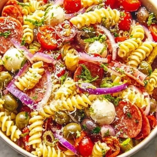 Bowl of legendary pasta salad with fresh vegetables and dressing