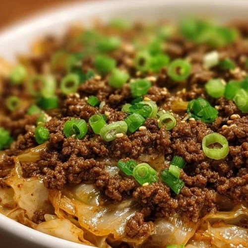 Plate of Low-Carb Mongolian Ground Beef and Cabbage with fresh herbs